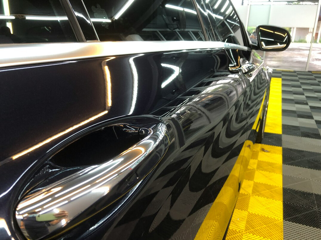 Freshly repaired glossy car body with a flawless finish